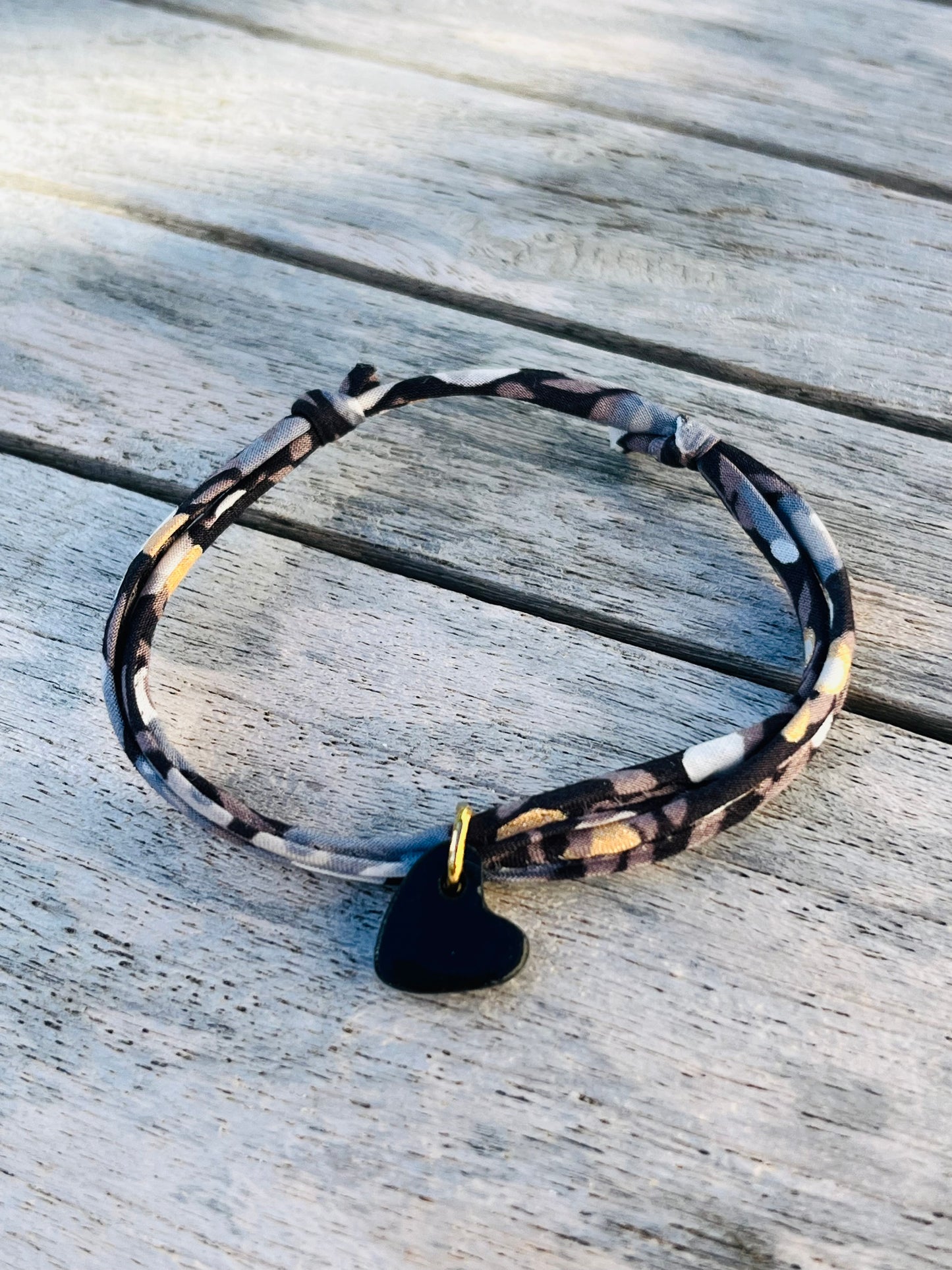 Bracelet tissu foncé, pois dorés, coeur noir